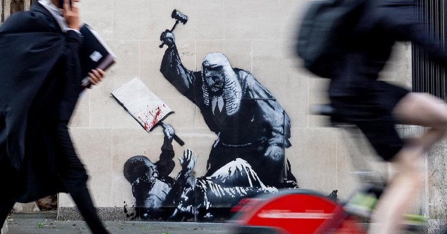 New Banksy showing judge hitting protester with gavel appears on High Court post thumbnail image