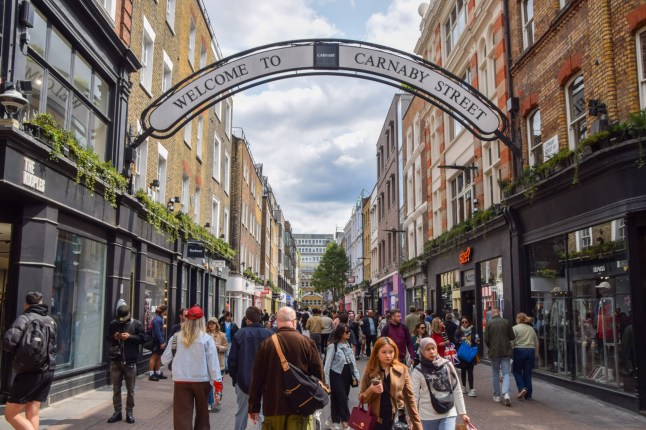 London, UK - June 8 2025: people walk along Carnaby Street.