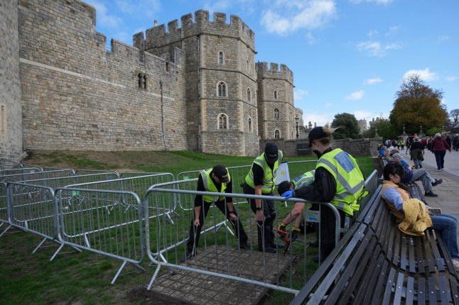 Police officers carry out security searches outside the Windsor Castle in Windsor, England, Monday, Sept. 15, 2025, ahead of the state visit of U.S. President Donald Trump. (AP Photo/Kin Cheung)