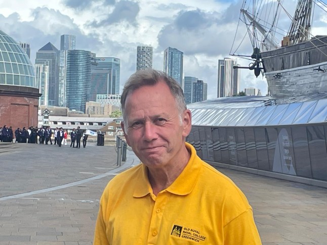 A man is seen wearing a yellow shirt outside of the cutty sark in south east London